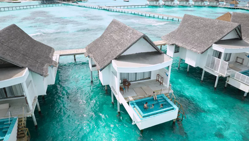 - Blending the blues of the lagoon with a modern aesthetic - The Club Sunset Overwater Villa offers a stylish and serene retreat above the water.