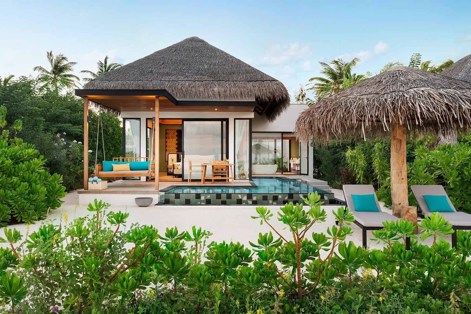 - 138 sq. m. / 1485 sq. ft., sofa bed, private pool, direct beach access - This well designed villa with direct beach access accommodates up to 2 adults and 2 children below 12 years. The lushly landscaped outdoor space features space to play: a pool and sundeck with dining area and a swing, and a gazebo with sun loungers - The villa includes a king size bed, comfortably sized sofa bed, complimentary WiFi, coffee / tea facilities, a 55 inch HDTV, laptop safe, air conditioning, mini bar, and ceiling fan Additional amenities include an ensuite bathroom, outdoor shower, bathrobes, and slippers Sleeps 3 adults with a sofa bed