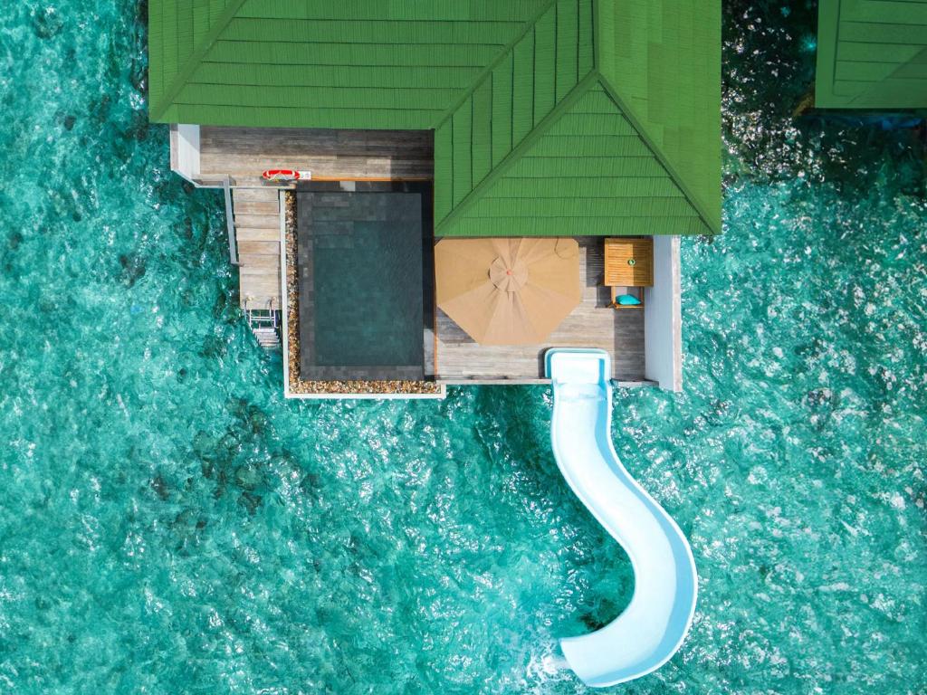 - These playful Water Villas offer a private pool with an exhilarating slide, making your stay unforgettable Enjoy your own sundeck with loungers, a bathroom with an indoor shower, mini bar, and WiFi With stunning views and the lagoon just steps away, it's the perfect blend of fun and relaxation
