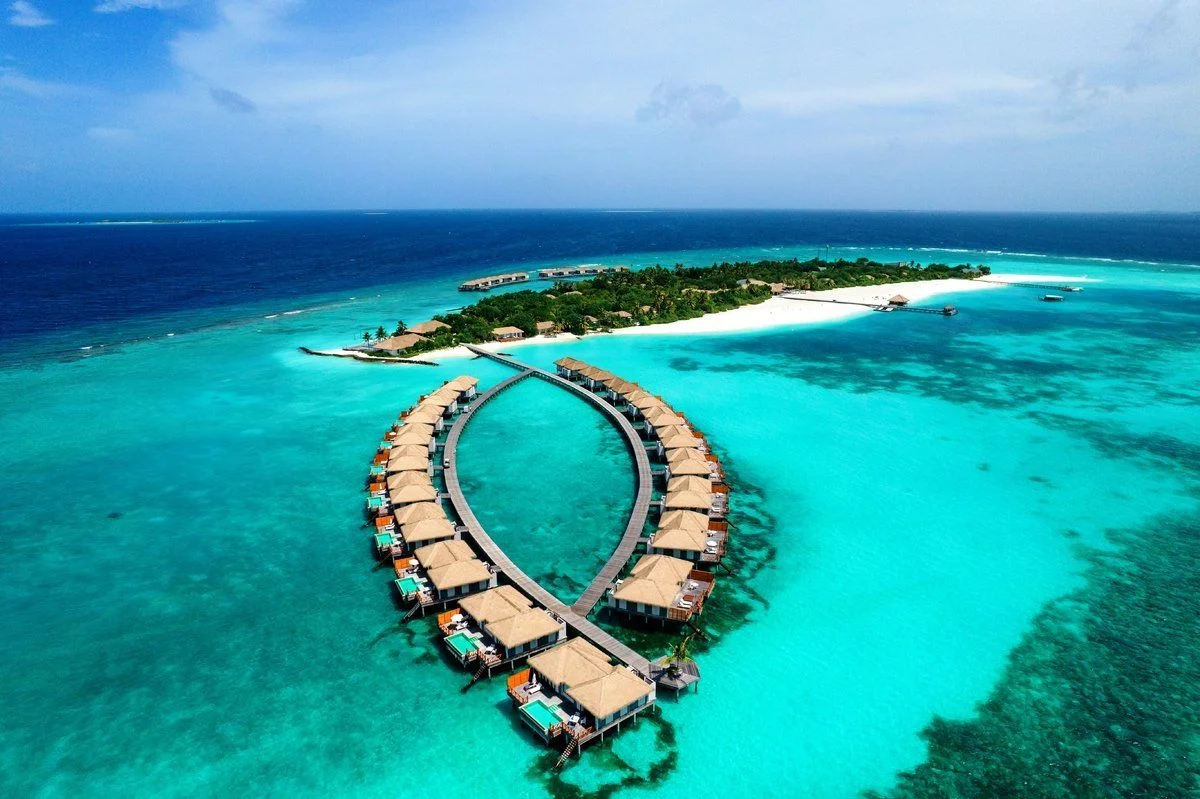 Noku Maldives is an intimate luxury retreat located in the untouched beauty of Noonu Atoll, offering a peaceful escape surrounded by crystal-clear lagoons, white sandy beaches, and lush tropical landscapes. Designed for travelers seeking privacy, tranquility, and authentic island experiences, the resort combines contemporary elegance with warm Maldivian hospitality.
With a limited number of spacious beach and overwater villas, Noku Maldives provides an exclusive atmosphere where guests can fully disconnect from everyday life and reconnect with nature. From world-class dining and wellness experiences to snorkeling, diving, and unforgettable ocean adventures, every detail is thoughtfully crafted to create a truly relaxing island getaway.
Whether you're planning a honeymoon, a romantic retreat, or a peaceful luxury escape, Noku Maldives delivers an experience defined by serenity, privacy, and natural beauty.