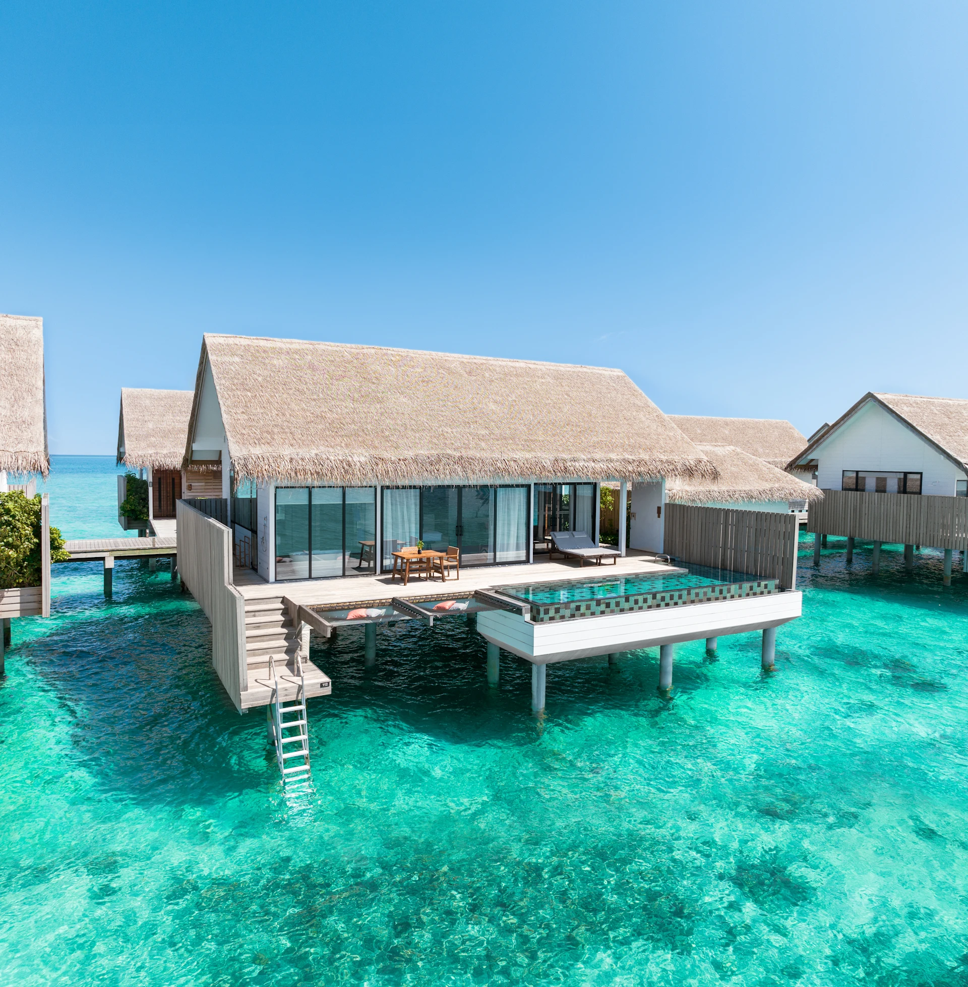 - 154 sq. m. / 1657 sq. ft., private pool, direct access to ocean - This beautiful villa provides a sense of island living, with direct access to the ocean. A glass panel in the floor allows views of the turquoise waters below. The outdoor space features a pool and sundeck with dining area, sun loungers, and a hammock - The villa includes a king size bed, complimentary WiFi, coffee / tea facilities, a 55 inch HDTV, laptop safe, air conditioning, mini bar, and ceiling fan Additional amenities include an ensuite bathroom, outdoor shower, bathrobes, and slippers Sleeps 3 with a rollaway bed.