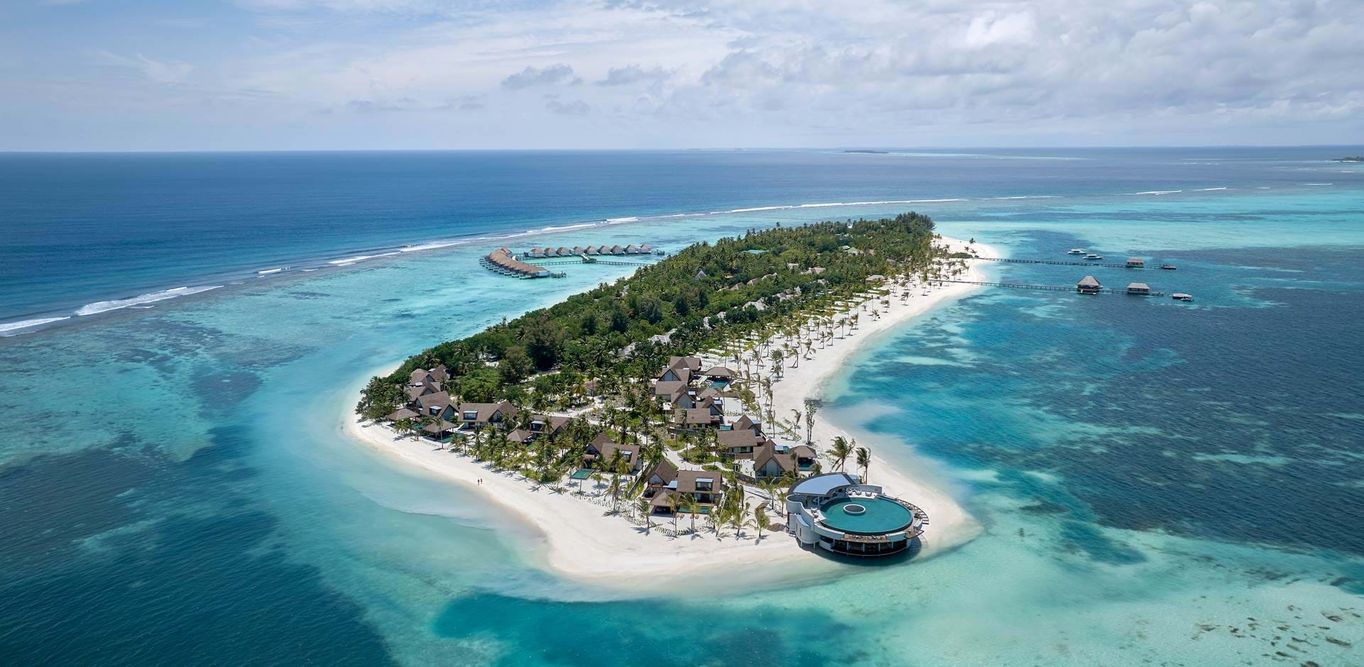 Six Senses Kanuhura is an exceptional luxury retreat located in the pristine Lhaviyani Atoll, offering a perfect blend of barefoot luxury, natural beauty, and world-class hospitality. Surrounded by turquoise lagoons, powder-soft beaches, and vibrant marine life, the resort provides an idyllic escape for travelers seeking privacy, relaxation, and meaningful experiences in the Maldives.
Renowned for its sustainability initiatives and signature wellness philosophy, Six Senses Kanuhura features elegant beachfront and overwater villas, exceptional dining experiences, and a wide range of activities designed to connect guests with nature. The resort also offers exclusive access to two private neighboring islands, creating an even greater sense of space, privacy, and adventure.
Whether you're planning a romantic honeymoon, a family holiday, or a wellness-focused getaway, Six Senses Kanuhura delivers an unforgettable island experience where luxury, nature, and wellbeing exist in perfect harmony.